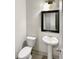 Well-lit powder room featuring modern fixtures, pedestal sink, and a sleek design at 3671 Salvia Dr, Buford, GA 30519
