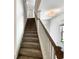 Carpeted stairs with white trim and a wooden handrail leading to the upper level at 3671 Salvia Dr, Buford, GA 30519