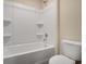 A clean bathroom with a combo tub and shower unit at 117 Oliver Dr, Locust Grove, GA 30248