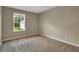 Bedroom with carpet and a view of the yard at 117 Oliver Dr, Locust Grove, GA 30248