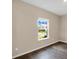 Neutral bedroom featuring modern wood-look flooring, a window with blinds, and neutral walls at 117 Oliver Dr, Locust Grove, GA 30248