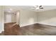 Bright and airy living area with wood flooring and access to other rooms at 117 Oliver Dr, Locust Grove, GA 30248