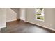 Living room with wood-look floors, a window, and neutral walls at 117 Oliver Dr, Locust Grove, GA 30248