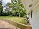 A large backyard with mature trees and a shed, as seen from a porch with wooden railing at 4222 Castle Pines Ct, Tucker, GA 30084