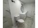 This bright bathroom features marble tile, a sink with vanity, a toilet and a circular mirror at 4222 Castle Pines Ct, Tucker, GA 30084