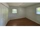 This cozy bedroom features hardwood floors, a window with natural light and a closet with double doors at 4222 Castle Pines Ct, Tucker, GA 30084