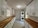 Spacious laundry room with built-in cabinetry, butcher block counters, and a stacked washer/dryer at 4222 Castle Pines Ct, Tucker, GA 30084