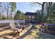 Beautifully landscaped backyard featuring a pergola, wooden chairs, and a white picket fence for serene outdoor living at 1110 Vernon Springs Ct, Atlanta, GA 30327