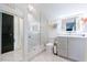 Modern bathroom features a glass shower, sleek gray cabinets, and tiled flooring at 1110 Vernon Springs Ct, Atlanta, GA 30327