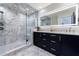 Stunning bathroom with glass enclosed shower, marble floors and tiling, plus sleek, modern dual vanity at 1110 Vernon Springs Ct, Atlanta, GA 30327