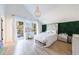 Stylish bedroom featuring bright windows, a vanity, a chandelier, and greenery backdrop at 1110 Vernon Springs Ct, Atlanta, GA 30327