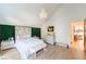 Modern bedroom showcases a green accent wall, decorative headboard, and chic furnishings at 1110 Vernon Springs Ct, Atlanta, GA 30327