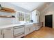 Sun-filled kitchen with white cabinets, white countertops, farmhouse sink, and stainless steel appliances at 1110 Vernon Springs Ct, Atlanta, GA 30327