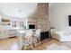 Modern kitchen with a brick fireplace and barstool seating at 1110 Vernon Springs Ct, Atlanta, GA 30327