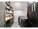 Efficient laundry room with modern washer/dryer units, stylish tile flooring, and shelving for organized storage at 1110 Vernon Springs Ct, Atlanta, GA 30327