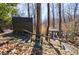 Exterior view of outbuildings with stairs and walkways nestled in the wooded landscape at 1110 Vernon Springs Ct, Atlanta, GA 30327