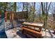 Outdoor deck area with dining table and stairs to the pool and seating area at 1110 Vernon Springs Ct, Atlanta, GA 30327