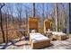 Outdoor deck area with wicker seating, wooded views and fire pit at 1110 Vernon Springs Ct, Atlanta, GA 30327