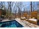 A private pool surrounded by a spacious deck with outdoor seating amid a lush woodland setting at 1110 Vernon Springs Ct, Atlanta, GA 30327