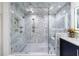 Sleek glass-enclosed shower with white marble tile, multi-jet fixtures, and built-in bench for spa-like comfort at 1110 Vernon Springs Ct, Atlanta, GA 30327