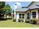 Green backyard featuring lush lawn, mature trees, manicured flower beds, and a well-maintained exterior at 2480 Copper Mill Trl, Cumming, GA 30041