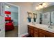 Bathroom showcasing double sinks and a view into an adjacent bedroom, all illuminated by natural light at 2480 Copper Mill Trl, Cumming, GA 30041