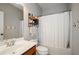 Cozy bathroom featuring a shower and tub combination with a white shower curtain and a neutral color scheme at 2480 Copper Mill Trl, Cumming, GA 30041