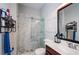 Well-lit bathroom featuring a marble tile shower with glass doors, decorative art, and neutral walls at 2480 Copper Mill Trl, Cumming, GA 30041