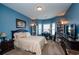Bedroom with blue walls, neutral carpet, ample storage, and bright natural light from the bay window at 2480 Copper Mill Trl, Cumming, GA 30041