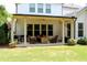 Inviting covered patio with seating, a ceiling fan, and a grill for outdoor entertaining at 2480 Copper Mill Trl, Cumming, GA 30041