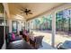 Inviting covered patio with outdoor seating, a ceiling fan, and a beautiful view of the private backyard at 2480 Copper Mill Trl, Cumming, GA 30041