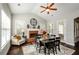 Bright dining room with a brick fireplace, dark wood table and large windows at 2480 Copper Mill Trl, Cumming, GA 30041