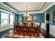 Elegant dining room with a large table, chandelier, and beautiful wall decor at 2480 Copper Mill Trl, Cumming, GA 30041