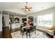 Cozy dining room featuring a dark wood table, a ceiling fan, and an open view to the kitchen at 2480 Copper Mill Trl, Cumming, GA 30041