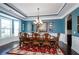 Elegant dining room with a large table, chandelier, and tray ceiling at 2480 Copper Mill Trl, Cumming, GA 30041