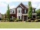 Charming two-story brick home with a well-manicured lawn and mature landscaping at 2480 Copper Mill Trl, Cumming, GA 30041