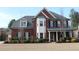 Beautiful two-story brick home with a manicured lawn and a welcoming front porch at 2480 Copper Mill Trl, Cumming, GA 30041