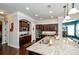 Kitchen with a large island featuring granite countertops, stainless steel appliances, and ample cabinet space at 2480 Copper Mill Trl, Cumming, GA 30041