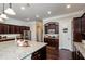 Well-appointed kitchen with granite countertops, dark wood cabinetry, stainless steel appliances, and ample counter space at 2480 Copper Mill Trl, Cumming, GA 30041