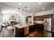 Bright open kitchen with dark wood cabinets, granite countertops, and stainless steel appliances at 2480 Copper Mill Trl, Cumming, GA 30041