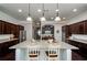 Bright kitchen featuring a spacious granite island, dark wood cabinets and stainless steel appliances at 2480 Copper Mill Trl, Cumming, GA 30041