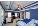 Bright main bedroom with a tray ceiling, ceiling fan and large windows at 2480 Copper Mill Trl, Cumming, GA 30041