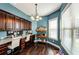 Home office featuring built-in dark wood cabinets, granite countertops and a window at 2480 Copper Mill Trl, Cumming, GA 30041