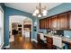 Office area with dark wood cabinets, granite countertops and view of open floor plan at 2480 Copper Mill Trl, Cumming, GA 30041