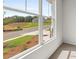 Bedroom window view of green landscaping, lawn, and new construction across the street at 303 Oak View Ln, Dallas, GA 30157