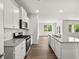 Open kitchen featuring white cabinets, stainless steel appliances and granite countertops at 303 Oak View Ln, Dallas, GA 30157