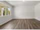 Bright living room features luxury vinyl plank flooring and a large window for natural light at 303 Oak View Ln, Dallas, GA 30157