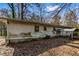 Back of home with horizontal siding, two windows, covered porch, and foundation with moss at 3160 Ann Se Rd, Smyrna, GA 30080