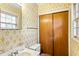 Bathroom featuring a closet and a window over the sink and toilet at 3160 Ann Se Rd, Smyrna, GA 30080