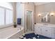 Bright bathroom with a soaking tub under a window and a separate glass shower at 4162 Gateswalk Se Dr, Smyrna, GA 30080